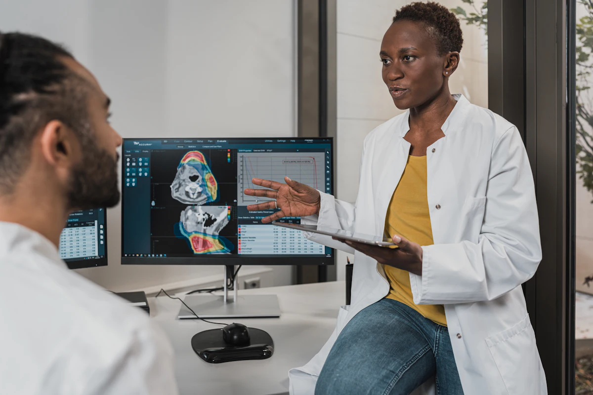 Clinicians reviewing information on screens in a modern clinic